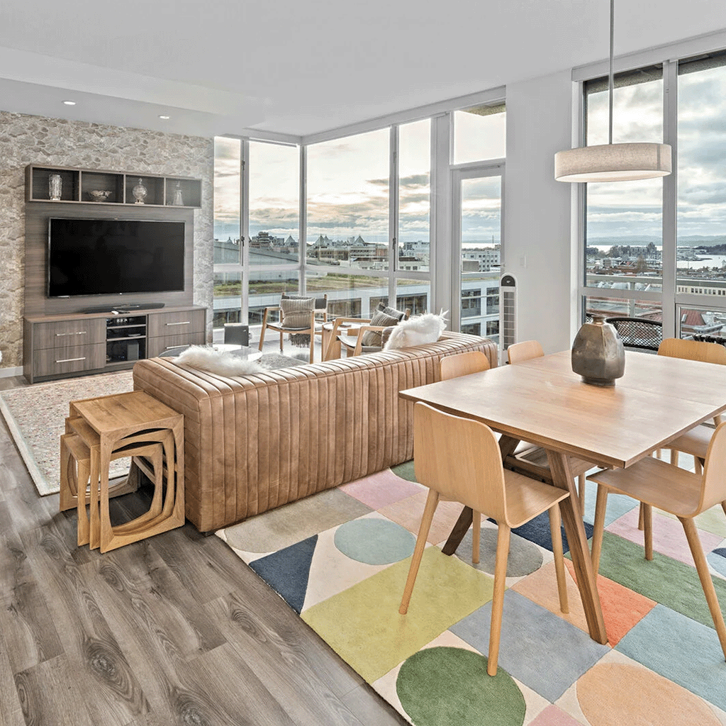 Bright dining room with modern furnishings and large windows showcasing coastal views in Victoria