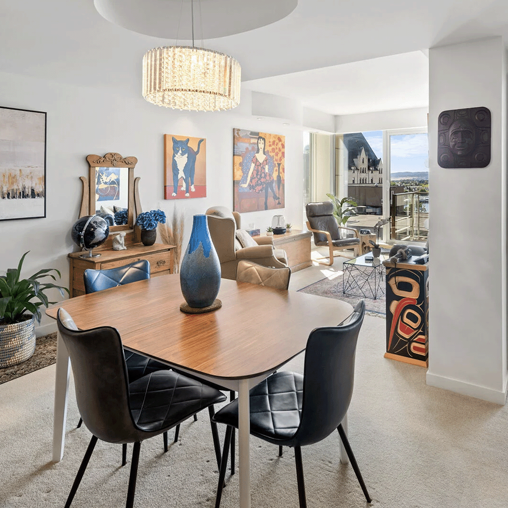 Eclectic dining room with unique art pieces, a modern chandelier, and views of the cityscape in Victoria